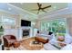 Inviting living room with a fireplace, large windows, and comfortable seating arrangement at 22338 Bartholdi Cir, Land O Lakes, FL 34639