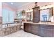 Beautiful main bathroom with a soaking tub, dual vanities, granite countertops and tiled floors at 22338 Bartholdi Cir, Land O Lakes, FL 34639