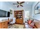 Cozy office features a built in bookcase, a ceiling fan, and a comfortable leather sofa at 22338 Bartholdi Cir, Land O Lakes, FL 34639