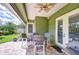 Covered patio with ceiling fan and outdoor dining furniture at 22338 Bartholdi Cir, Land O Lakes, FL 34639