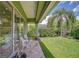 View of lush backyard and covered patio area at 22338 Bartholdi Cir, Land O Lakes, FL 34639