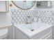 Bathroom vanity with a gold faucet, mirror and decorative tile backsplash at 2363 Newburg Ln # B, Safety Harbor, FL 34695