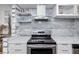 Close up of the sleek, stainless-steel stove and hood in a remodeled kitchen at 2363 Newburg Ln # B, Safety Harbor, FL 34695
