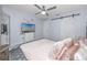 Bedroom featuring modern decor, a ceiling fan, and a sliding barn door closet at 2363 Newburg Ln # B, Safety Harbor, FL 34695