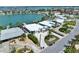 Stunning waterfront home featuring lush landscaping and a private dock on a canal leading to the open bay at 25 Dolphin Dr, Treasure Island, FL 33706