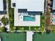 Beautiful waterfront home with a modern pool and stylish outdoor area leading to a private dock at 25 Dolphin Dr, Treasure Island, FL 33706