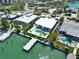 Picture of a waterfront home with a backyard pool, dock, and lush landscaping, perfect for relaxation and entertainment at 25 Dolphin Dr, Treasure Island, FL 33706