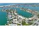 An elevated view capturing a neighborhood of waterfront homes, private docks, and a vast open bay at 25 Dolphin Dr, Treasure Island, FL 33706