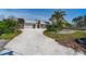 Contemporary home with a large driveway, two car garage, modern architectural features, and well-maintained landscaping at 25 Dolphin Dr, Treasure Island, FL 33706
