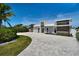 Beautifully designed modern home with a circular driveway and well-maintained landscaping at 25 Dolphin Dr, Treasure Island, FL 33706