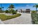 Stunning modern home with lush landscaping and a spacious driveway at 25 Dolphin Dr, Treasure Island, FL 33706