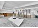 Open-concept interior with marble flooring, partially installed kitchen, and modern light fixtures at 25 Dolphin Dr, Treasure Island, FL 33706
