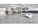 Renovated open-concept interior with modern marble flooring and partially installed kitchen cabinets at 25 Dolphin Dr, Treasure Island, FL 33706