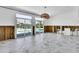Interior view featuring large sliding doors to the pool area, marble floors, and exposed wall framing at 25 Dolphin Dr, Treasure Island, FL 33706