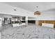 Large room with marble flooring and open concept, currently under construction with exposed framing at 25 Dolphin Dr, Treasure Island, FL 33706