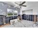 Spacious kitchen undergoing renovations with stylish wave wallpaper and a modern ceiling fan at 25 Dolphin Dr, Treasure Island, FL 33706