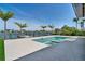 Beautiful backyard with a modern pool, travertine deck, and waterfront views at 25 Dolphin Dr, Treasure Island, FL 33706