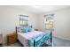 Charming bedroom with a metal frame bed, soft pink bedding, and natural light, providing a cozy and inviting atmosphere at 25337 Durango Ct, Punta Gorda, FL 33955