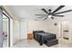 Cozy bedroom featuring a black metal frame bed, neutral walls, tiled floors, and a stylish ceiling fan, creating a comfortable retreat at 25337 Durango Ct, Punta Gorda, FL 33955