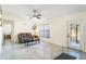 Bright living room with tile flooring, ceiling fan, and a comfortable seating arrangement at 25337 Durango Ct, Punta Gorda, FL 33955