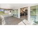 View of tiled screened patio with sliding doors accessing the game room with a wet bar at 25337 Durango Ct, Punta Gorda, FL 33955