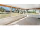 Screened patio with stone flooring and an expansive view of the lush backyard at 25337 Durango Ct, Punta Gorda, FL 33955