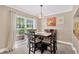 Cozy dining area featuring a wood table set for six with natural light from the window at 2897 Thaxton Dr # 62, Palm Harbor, FL 34684