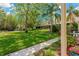 Scenic view of the property exterior, showcasing a well-kept lawn and surrounding mature trees at 2897 Thaxton Dr # 62, Palm Harbor, FL 34684