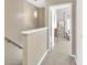 Hallway with carpet, view of the bedroom, and a hanging light fixture at 2897 Thaxton Dr # 62, Palm Harbor, FL 34684