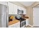 Kitchen features stainless steel appliances, updated cabinets, and butcher block countertops at 2897 Thaxton Dr # 62, Palm Harbor, FL 34684