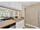 Bright kitchen with view to the adjacent dining room and stainless steel dishwasher at 2897 Thaxton Dr # 62, Palm Harbor, FL 34684