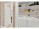 Convenient laundry room with washer, dryer, and storage shelves at 2897 Thaxton Dr # 62, Palm Harbor, FL 34684