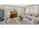 Bright living room featuring a neutral color palette, tile floors, piano, and comfortable seating at 2897 Thaxton Dr # 62, Palm Harbor, FL 34684