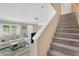 Sunlit living room with plush sofa and staircase leading to upper level at 2897 Thaxton Dr # 62, Palm Harbor, FL 34684