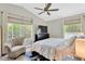 Bright bedroom with large windows, ceiling fan, and comfortable seating area at 2897 Thaxton Dr # 62, Palm Harbor, FL 34684