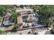 Aerial view displaying solar panels on the house, with a detached garage, surrounded by lush greenery at 3443 16Th Ave S, St Petersburg, FL 33711