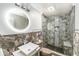 Modern bathroom with granite-style wall accents, square sink, and frameless shower with a built-in bench at 3443 16Th Ave S, St Petersburg, FL 33711