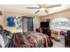 Comfortable bedroom with neutral walls, ceiling fan and an arched window view at 3443 16Th Ave S, St Petersburg, FL 33711