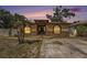 Charming single-story home featuring a decorative stone facade and a beautiful sunset backdrop at 3443 16Th Ave S, St Petersburg, FL 33711
