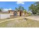 Charming single-story home featuring a decorative stone facade, driveway, and partial fencing at 3443 16Th Ave S, St Petersburg, FL 33711