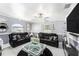 Stylish living room featuring modern decor, plush black leather sofas, and a unique glass coffee table at 3443 16Th Ave S, St Petersburg, FL 33711