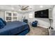 Spacious bedroom with a large bed, full-length mirror, TV, and comfortable seating at 3443 16Th Ave S, St Petersburg, FL 33711