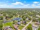 Expansive aerial view of a home with a pool, large yard, and waterfront access on a sunny day at 3626 Lake Joyce Dr, Land O Lakes, FL 34639