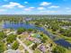 A stunning aerial perspective reveals a waterfront home with an in-ground pool and natural surroundings at 3626 Lake Joyce Dr, Land O Lakes, FL 34639