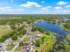 This aerial shot highlights a waterfront property with a beautiful view and in-ground pool at 3626 Lake Joyce Dr, Land O Lakes, FL 34639