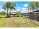 Outdoor space showcasing a gazebo, in-ground pool, screened enclosure, and a verdant lawn at 3626 Lake Joyce Dr, Land O Lakes, FL 34639