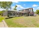 An in-ground pool with screened enclosure and a spacious, green yard are focal points of this backyard at 3626 Lake Joyce Dr, Land O Lakes, FL 34639