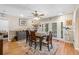 Dining room with wood floors, ceiling fan, a wooden table, and a sliding glass door to the exterior at 3626 Lake Joyce Dr, Land O Lakes, FL 34639