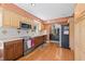 Well-lit kitchen with stainless steel appliances, wood cabinetry, and an open layout at 3626 Lake Joyce Dr, Land O Lakes, FL 34639