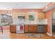Stylish kitchen with modern appliances, wooden cabinets, and a view to the backyard at 3626 Lake Joyce Dr, Land O Lakes, FL 34639